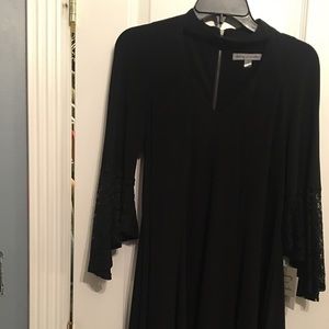 Black dress with lace peplum sleeves.